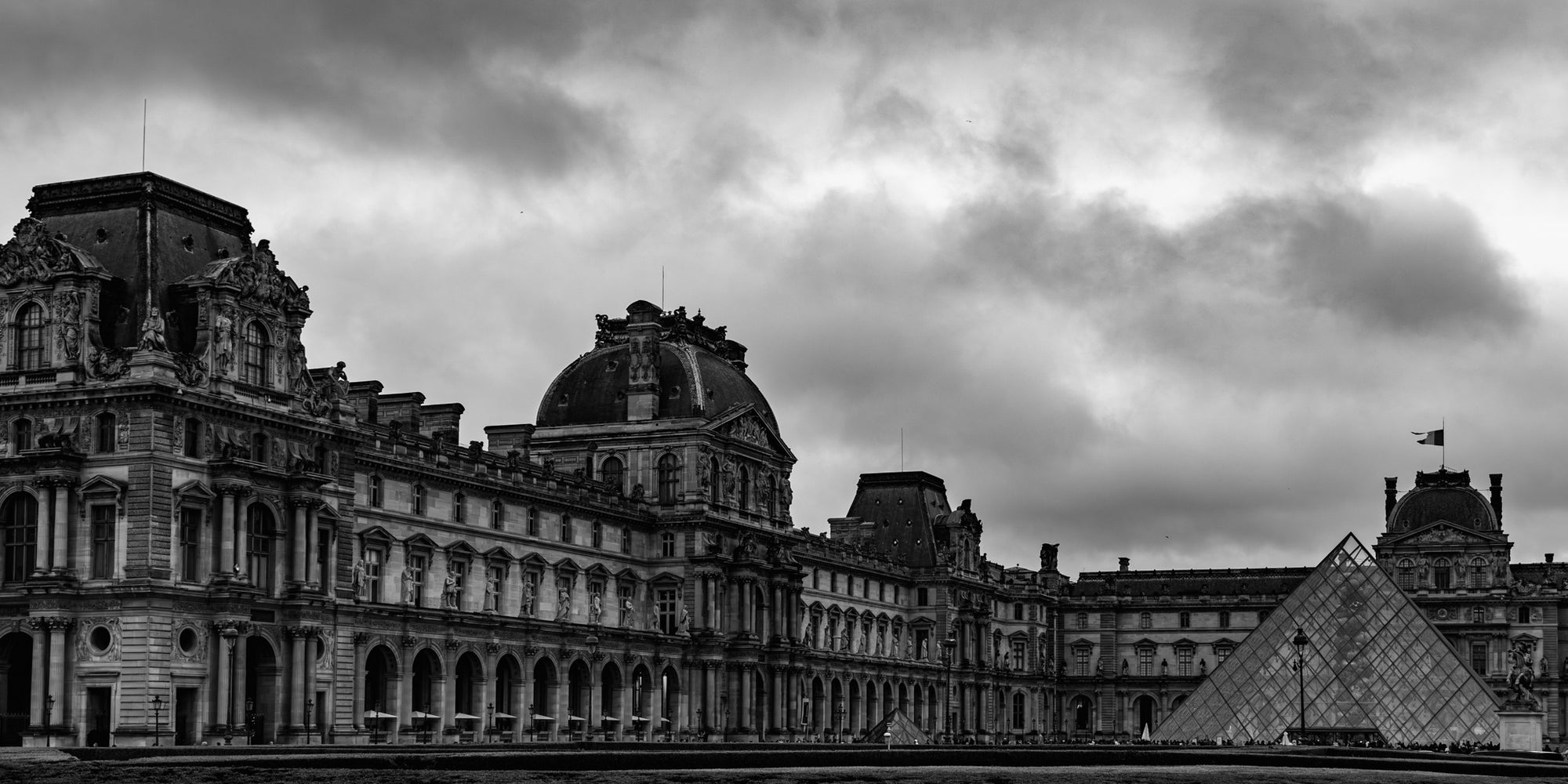 Black and white image of a famous landmark with a cloudy sky