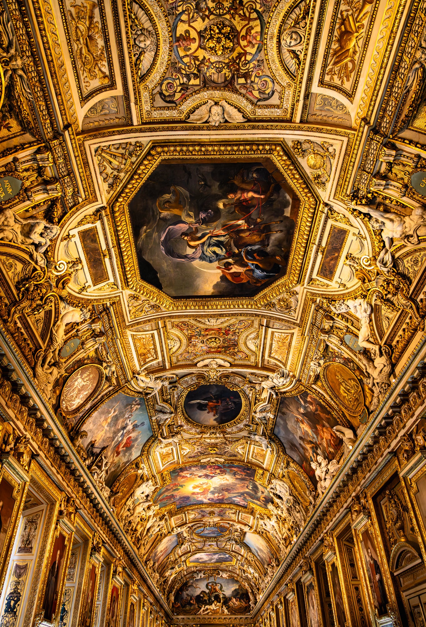 Ornate ceiling with paintings and gold accents
