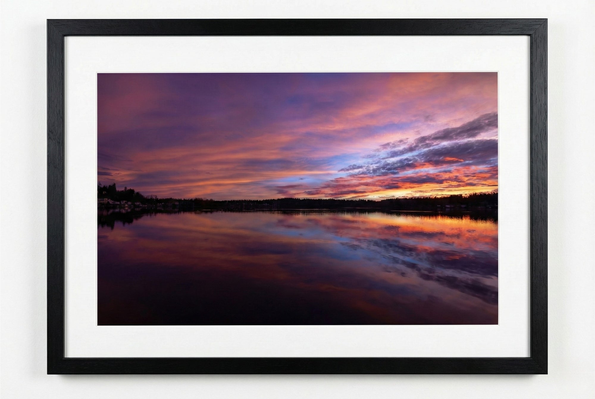 Framed photograph of a sunrise over water with vibrant purple and orange colors.