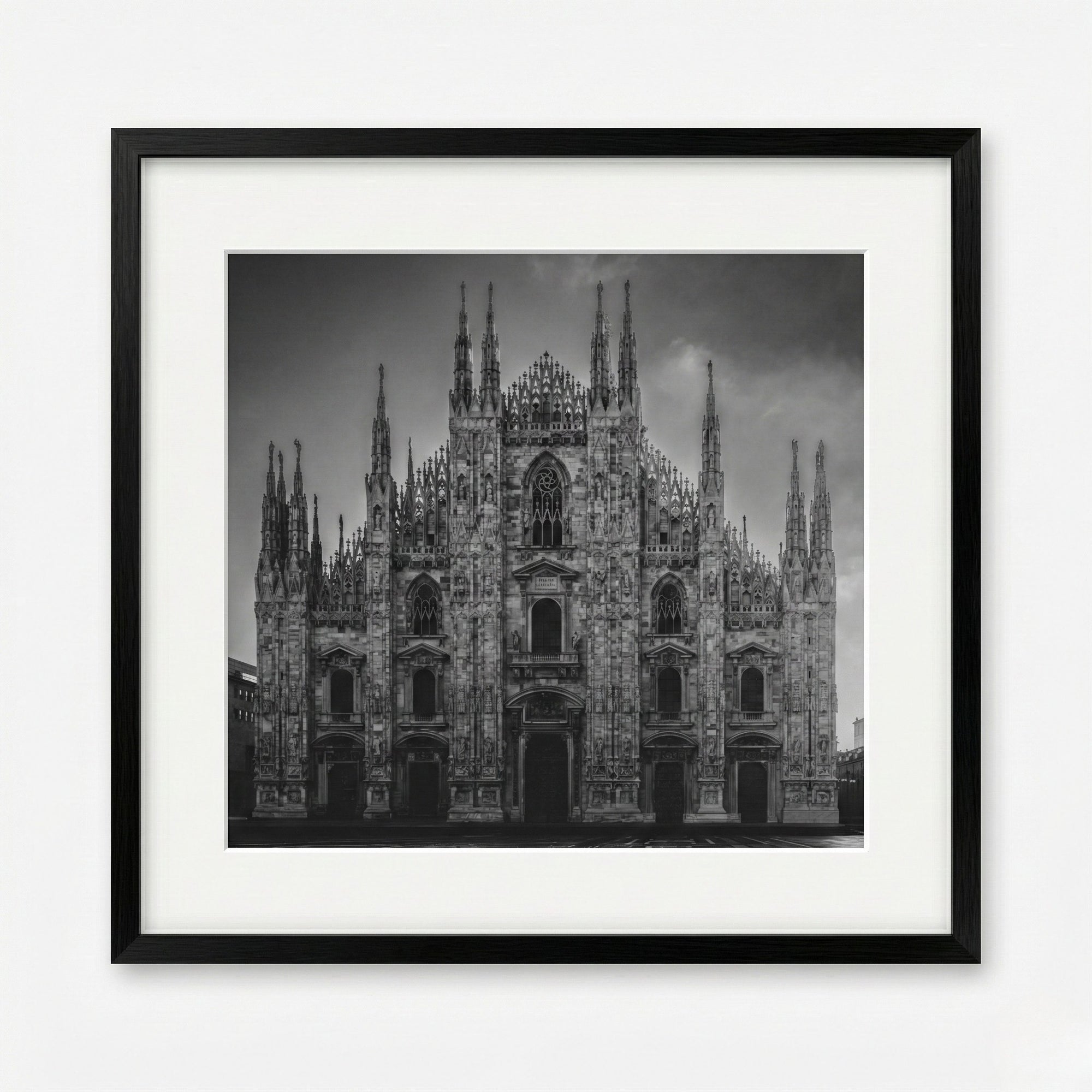 Framed black and white photograph of a cathedral with a dark sky.
