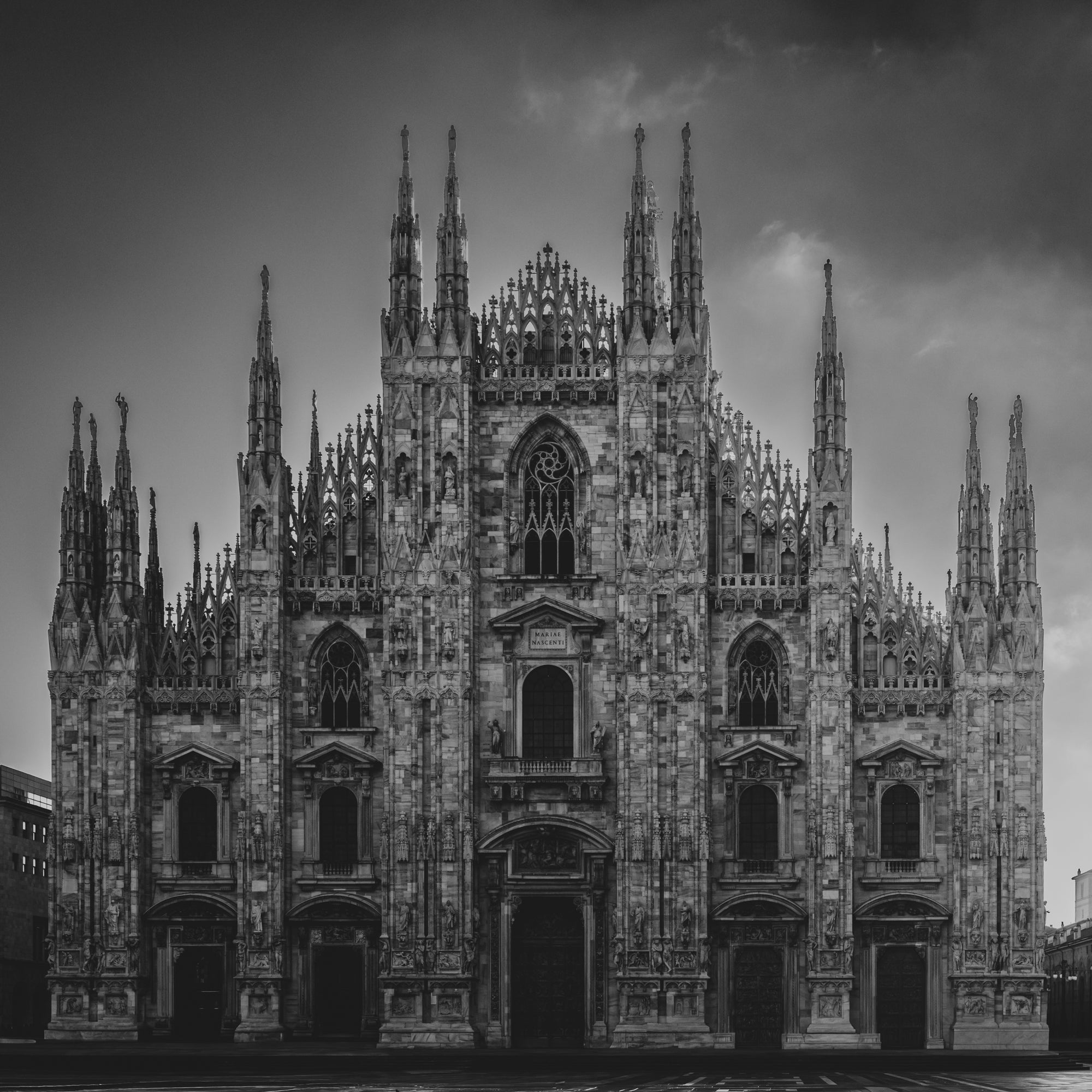 Gothic cathedral with intricate architecture against a cloudy sky