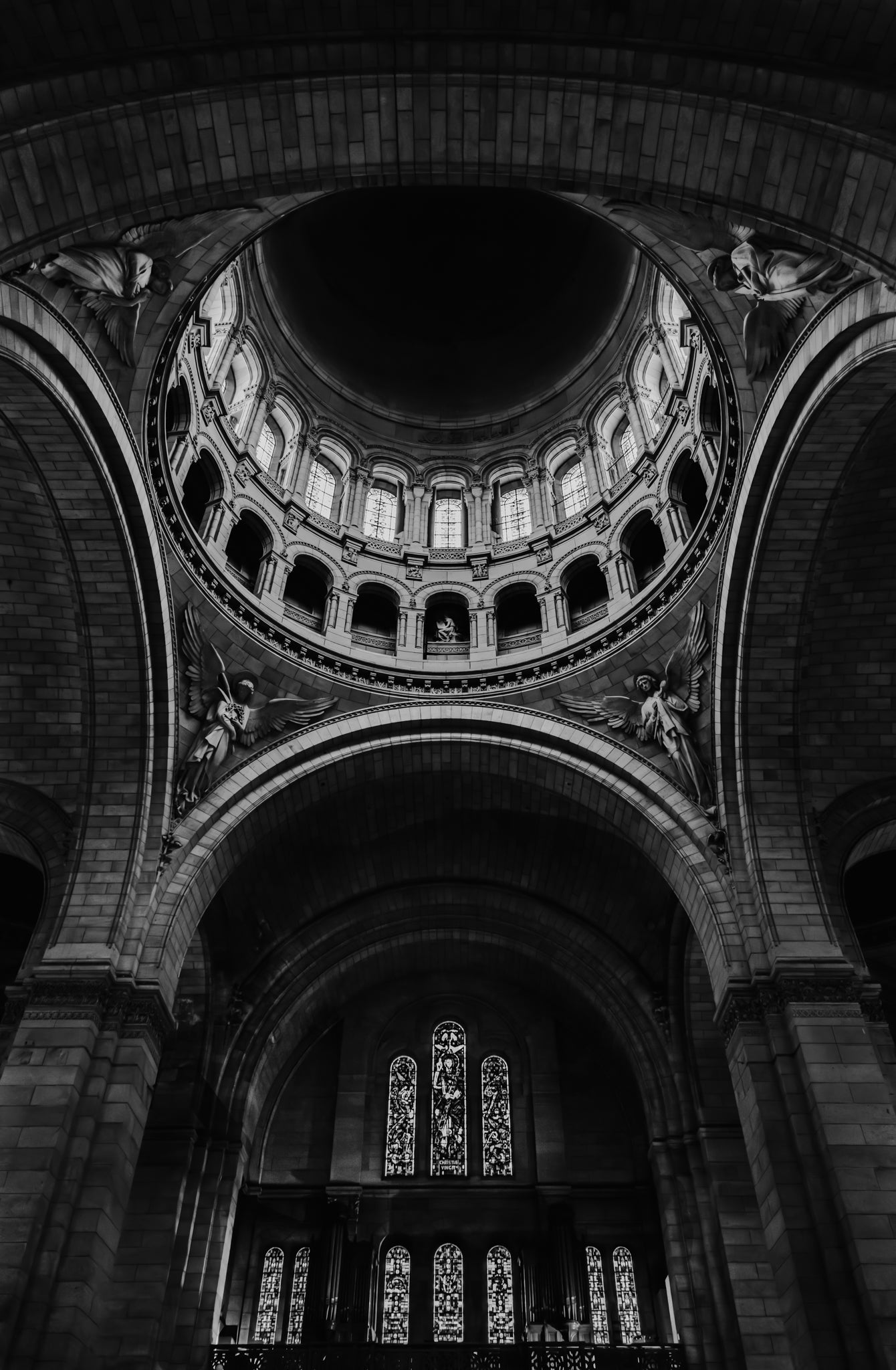 Interior of a cathedral with architectural details and stained glass windows.