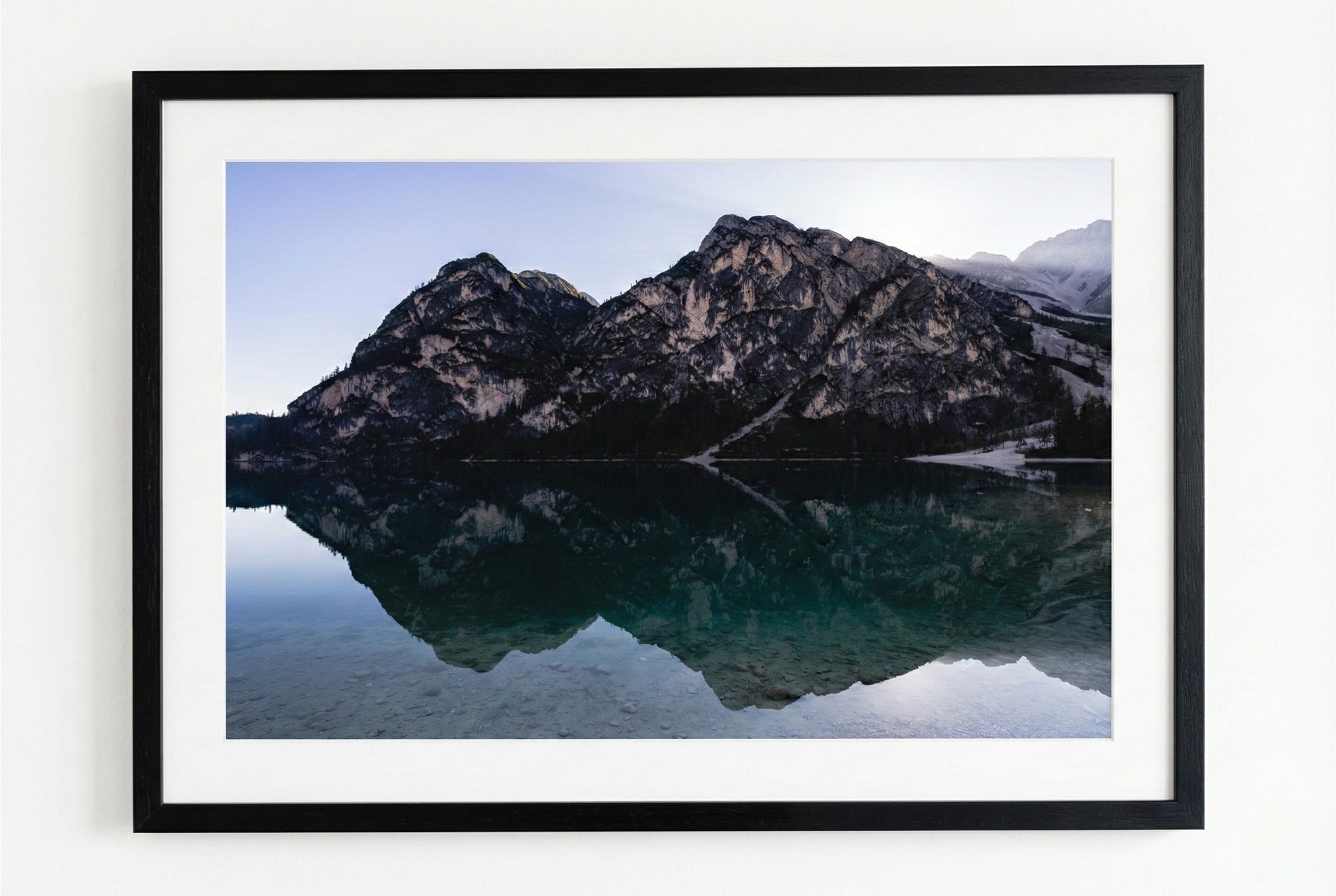 Framed photograph of a mountain reflection in water