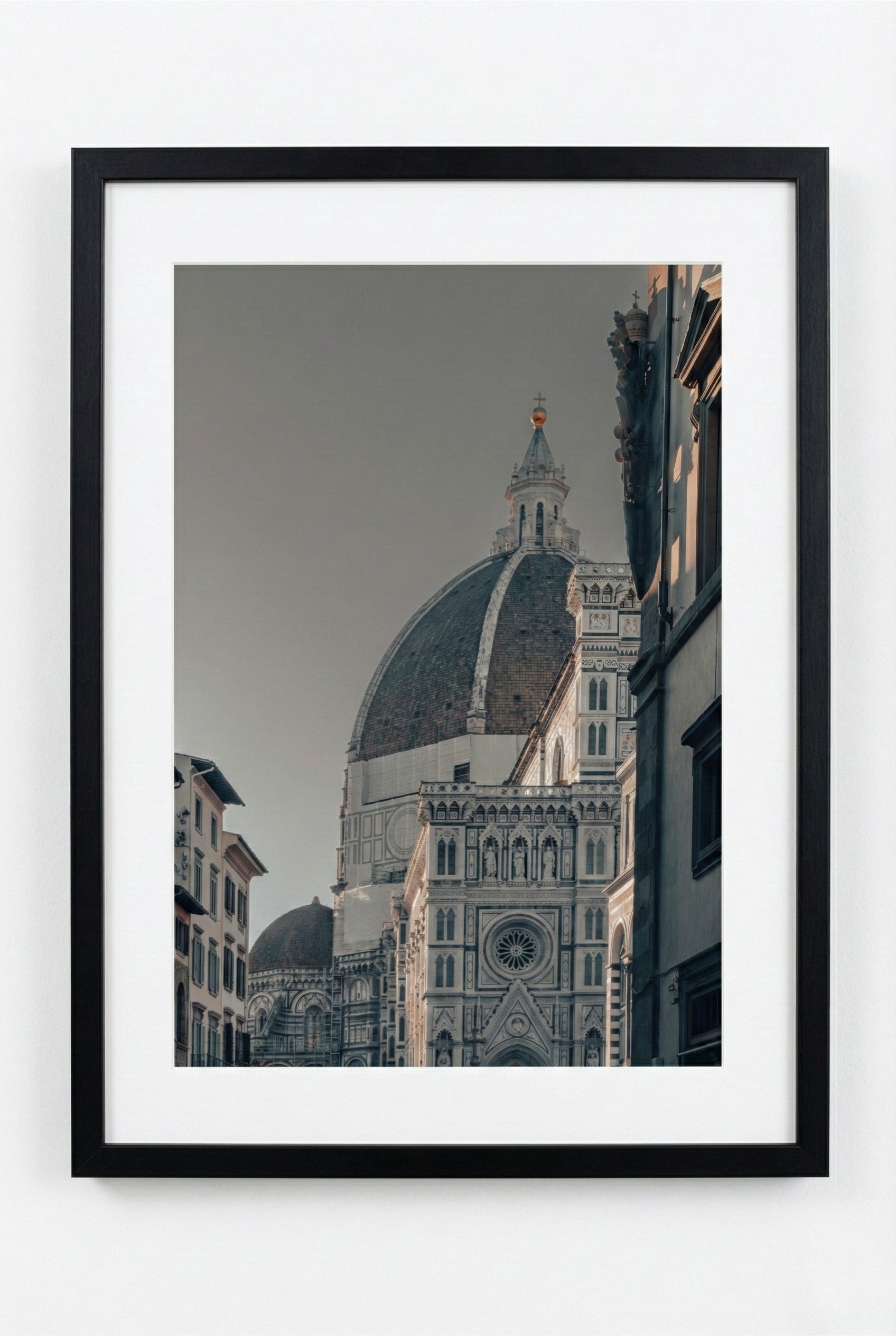 Framed photograph of a cathedral dome with a gray sky