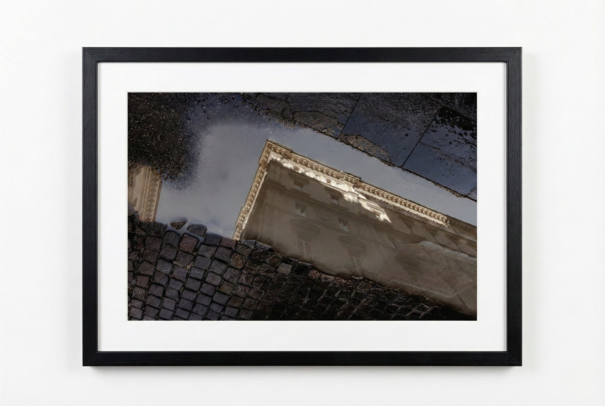 Framed artwork of a building corner with reflective surface