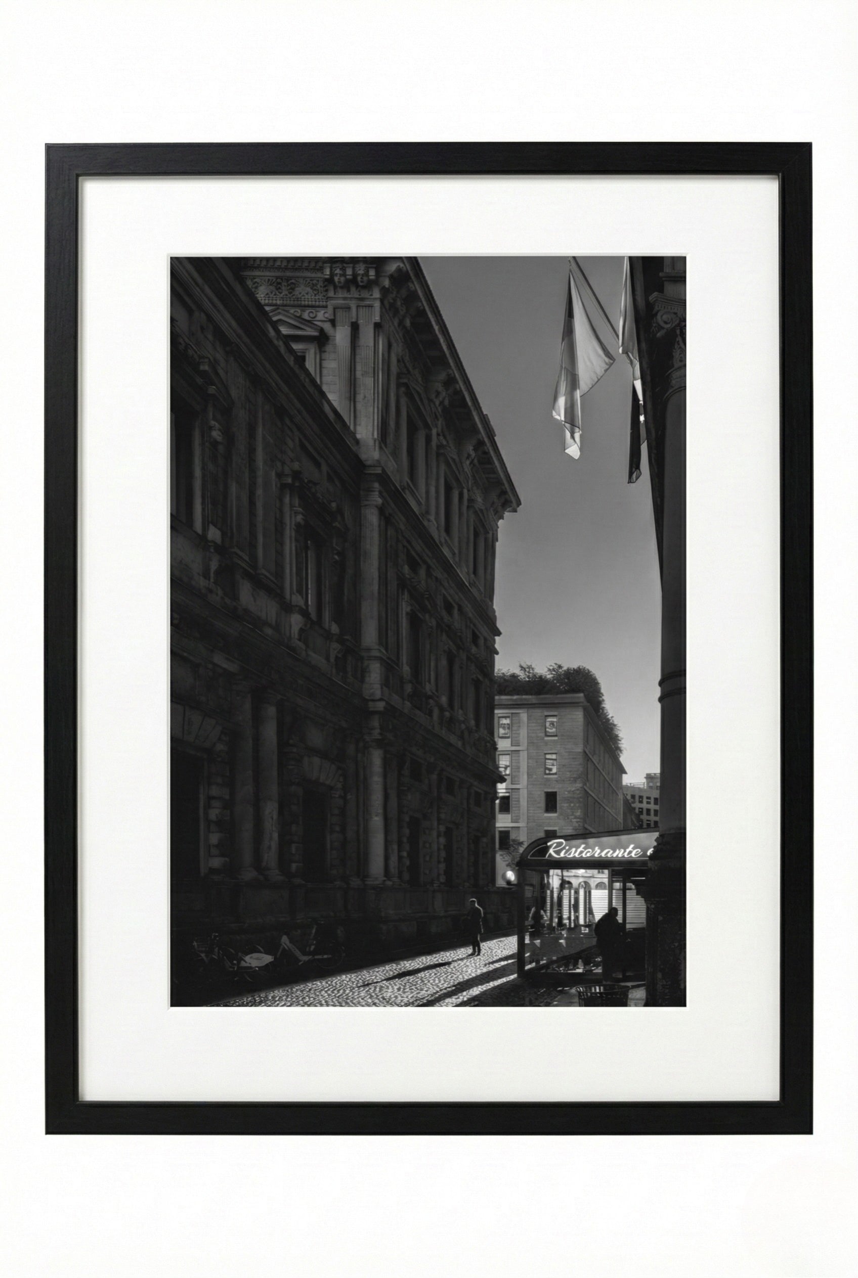 Black and white framed photograph of an urban street scene