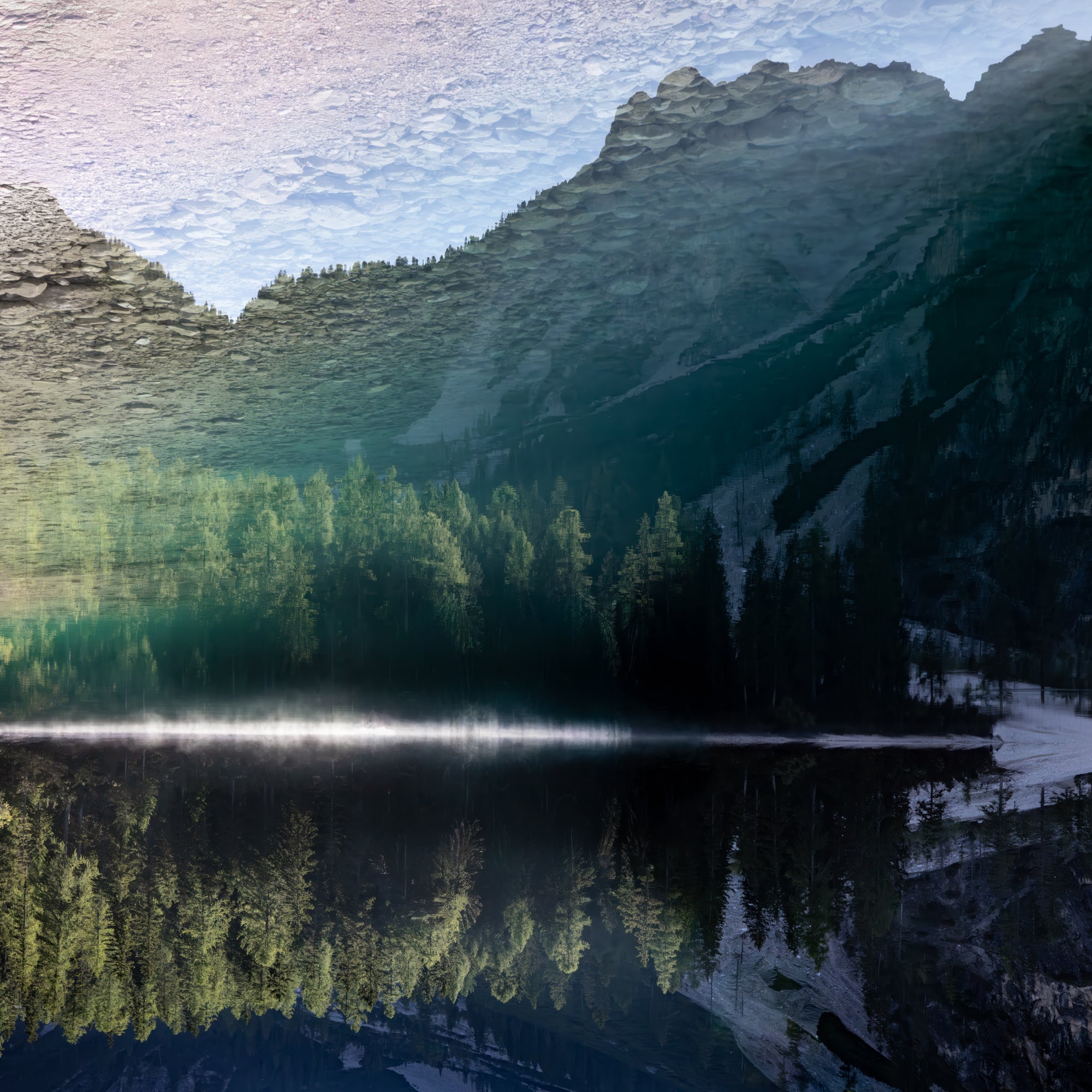 Mountain landscape with a lake reflecting the trees and mountains