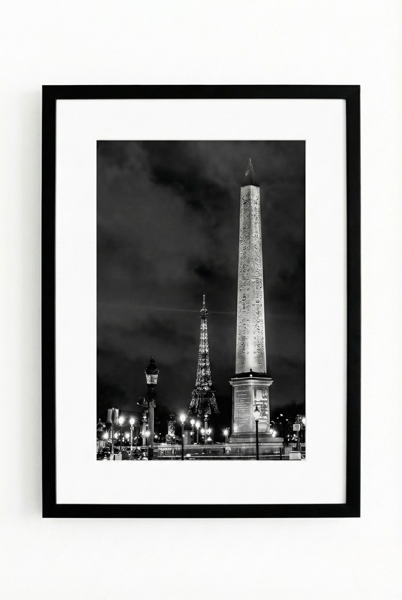 Framed black and white photo of the Eiffel Tower and Obelisk in Paris at night.