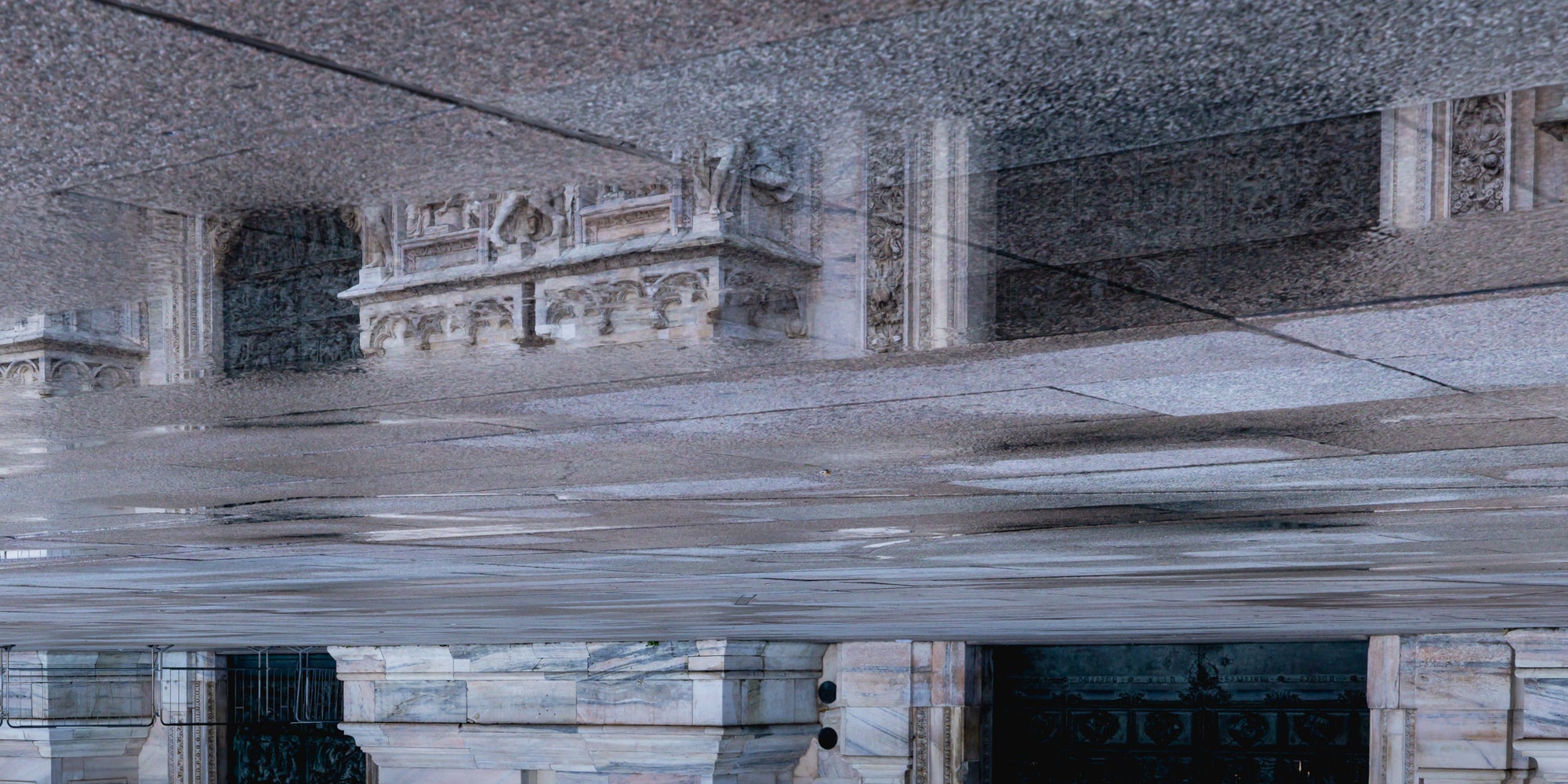 Reflective surface with architectural elements and textural patterns