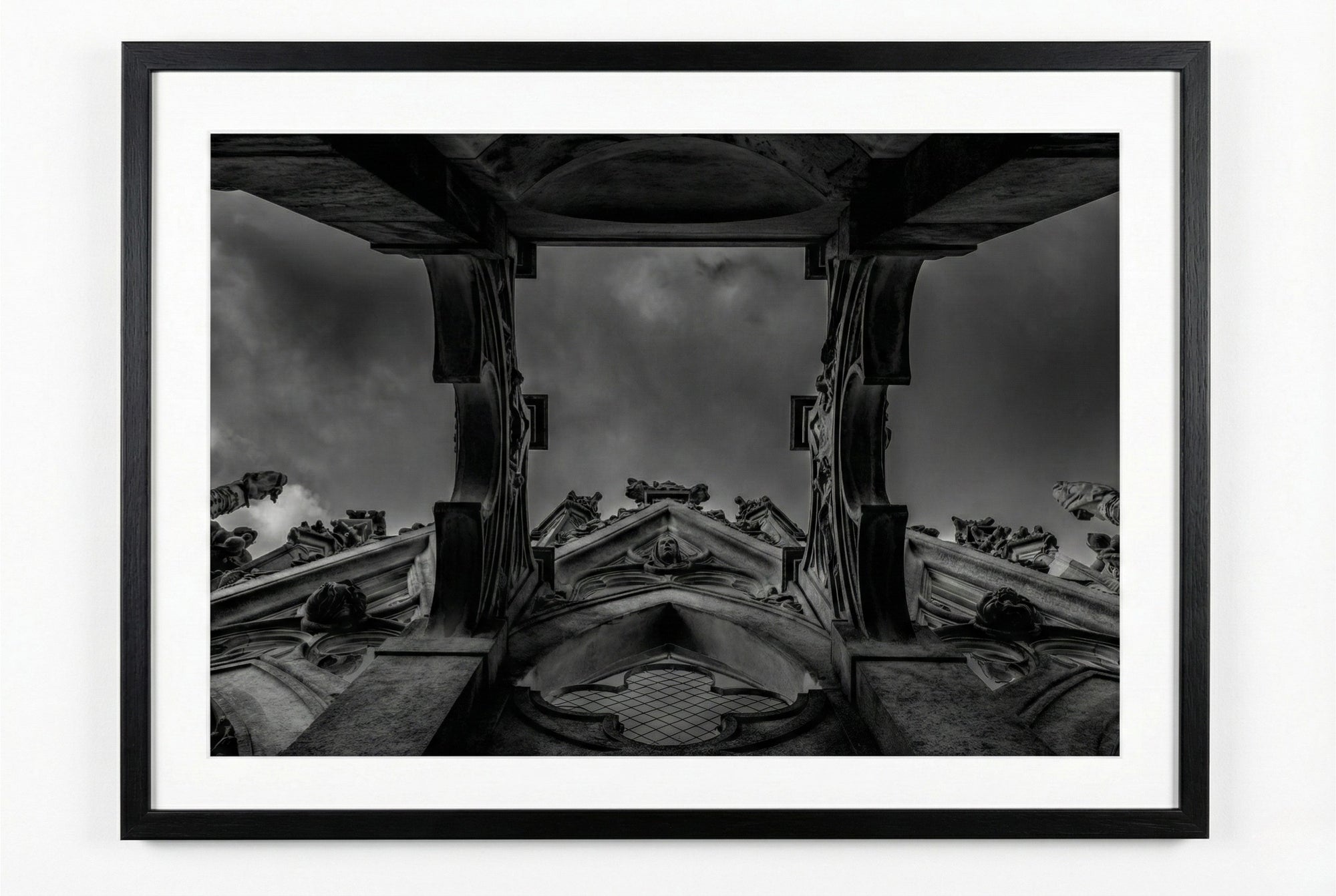 Black and white architectural photo of a cathedral roof with a dark sky.