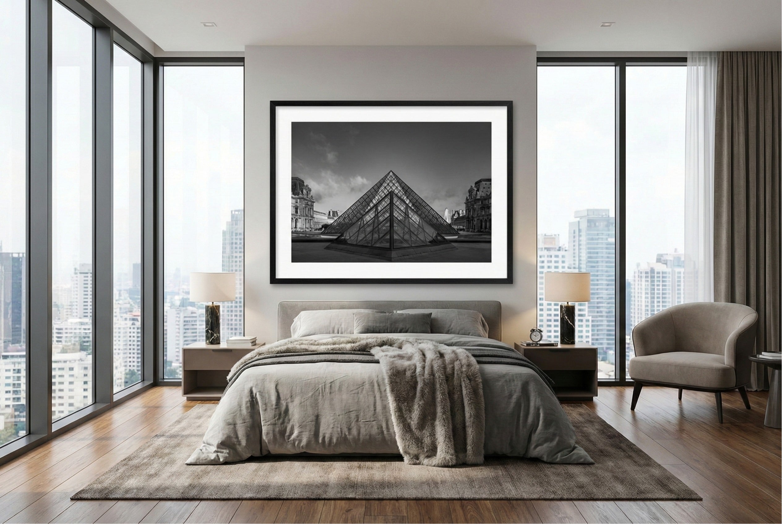 Modern bedroom with a large framed black and white photograph of two pyramids from the Louvre on the wall.